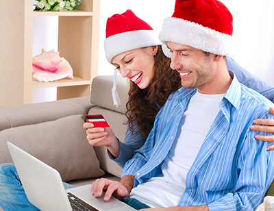 couple in santa hats shopping online